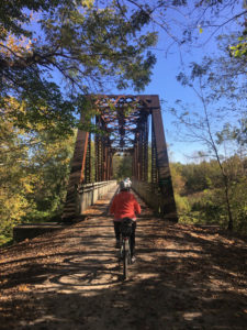 Woman bikes down the Katy Trail in Missouri